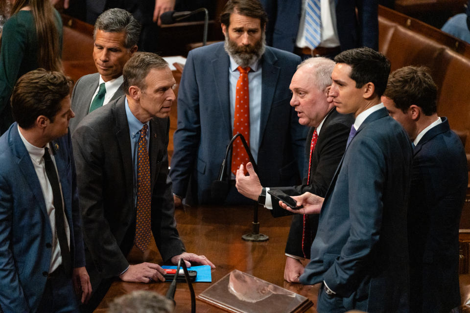 Rep. Steve Scalise speaks to Republican lawmakers, all of whom look discomfited or antagonistic.