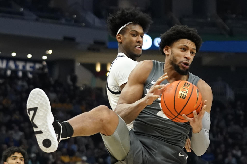 Xavier's Jerome Hunter, right, controls a rebound in front of Marquette's Olivier-Maxence Prosper during the first half of an NCAA college basketball game Wednesday, Feb. 15, 2023, in Milwaukee. (AP Photo/Aaron Gash)