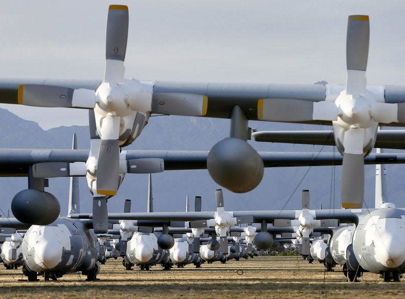 C-130 Hercules cargo planes are lined up in a field at the 309th Aerospace Maintenance and Regeneration Group boneyard at Davis-Monthan Air Force Base in Tucson, Ariz., on May 14. More than 2,300 variants of the C-130 have been produced since 1954. AP Photo/MATT YORK