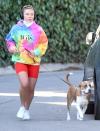 <p>Florence Pugh wears a colorful hoodie and red bike shorts while out for a jog wit her dog on Wednesday in L.A.</p>