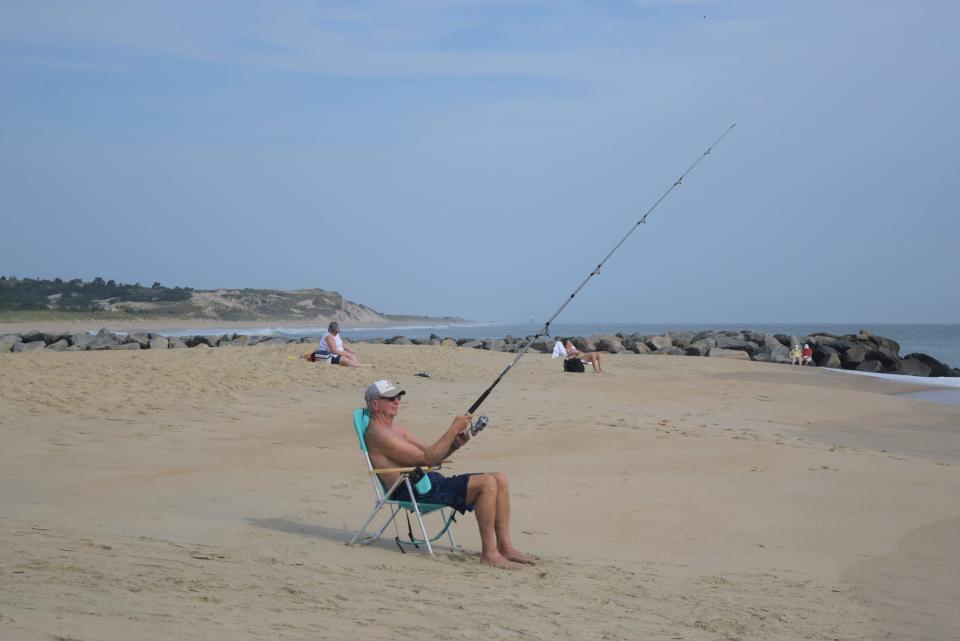 A fisherman enjoys an uncrowded beach at Herring Point at Cape Henlopen State Park the day after Labor Day, Sept. 5, 2023.