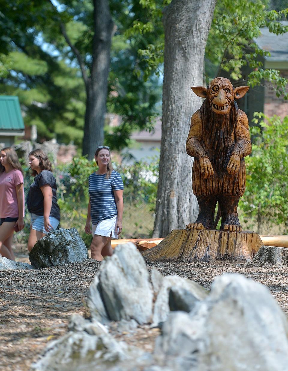 Visitors take in the sights of creatures carved from wood at Marty's Mythical Woods at Martin L. "Marty" Snook Memorial Park in Halfway in this 2021 file photo. If you need to clear your head this holiday, taking a walk at the park might help.