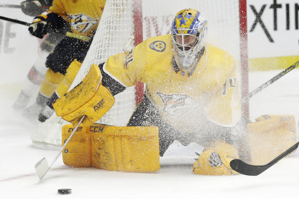 Nashville Predators goaltender Juuse Saros, of Finland, blocks a shot as he is sprayed with ice in the first period of an NHL hockey game between the Predators and the Ottawa Senators Tuesday, Feb. 25, 2020, in Nashville, Tenn. (AP Photo/Mark Humphrey)