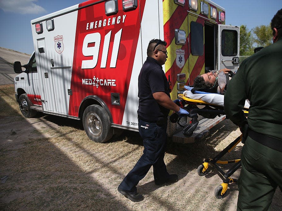 Paramedics and U.S. Border Patrol agents assist an undocumented immigrant after he collapsed from heat exhaustion after crossing from Mexico into the United States on August 7, 2015 in McAllen, Texas. The state's Rio Grande Valley corridor is the busiest illegal border crossing into the United States. Border security and immigration have become major issues in the U.S. presidential campaign.