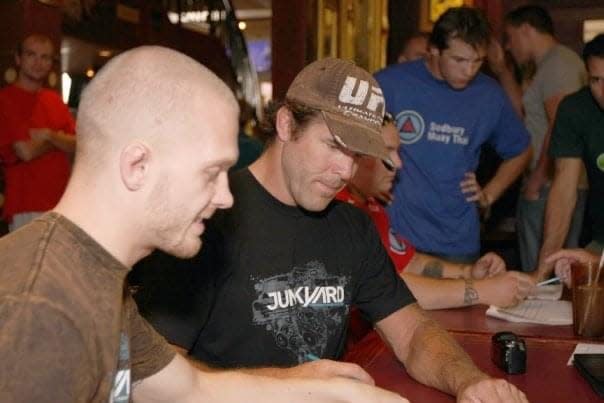 Evan Tanner (right) and Ian Dawe (left) sign autographs at a UFC event circa 2008.