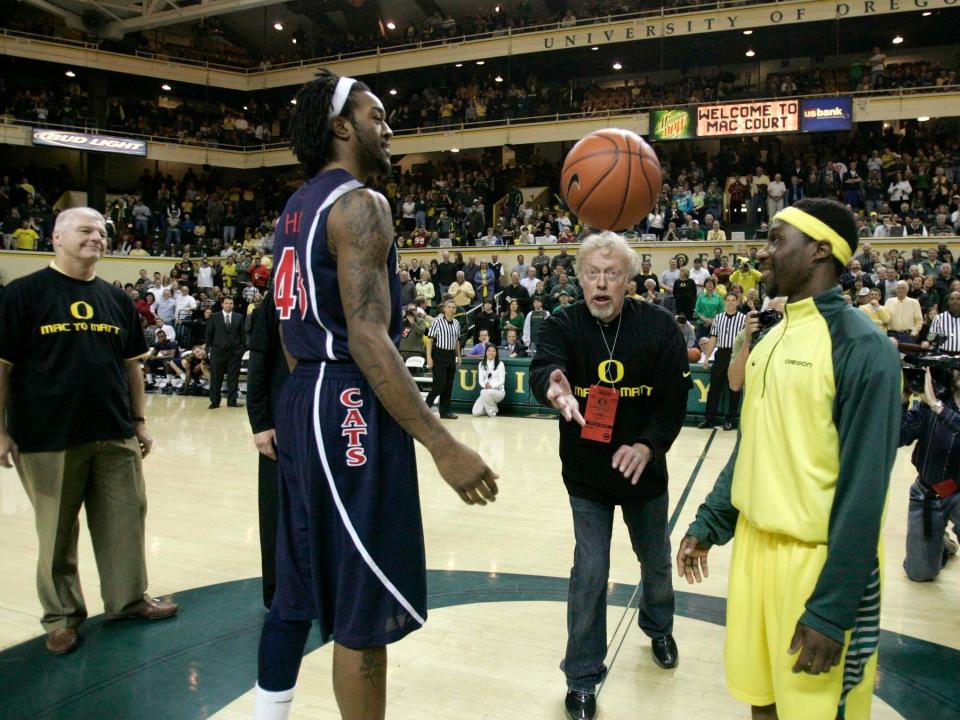 Knight, shown tossing up the ceremonial opening tip at a 2009 basketball game, has publicly acknowledged the role luck played in growing Nike.