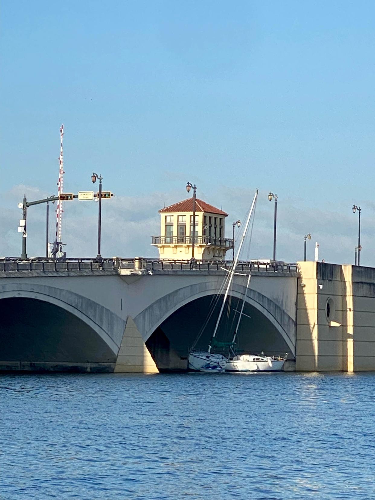 A sailboat leans against the Royal Park Bridge Tuesday in Palm Beach March 21, 2023. The vessel, which was tethered to another sailboat, drifted into the bridge Monday after being pulled along by a strong current and heavy winds. Both were removed Tuesday.