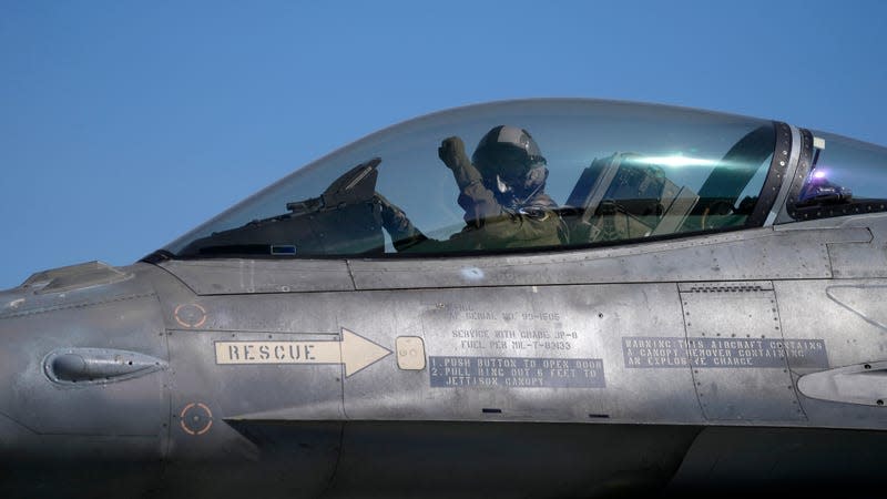 The pilot of a Greek Fighter Jet F-16 Viper salutes prior to takeoff. 