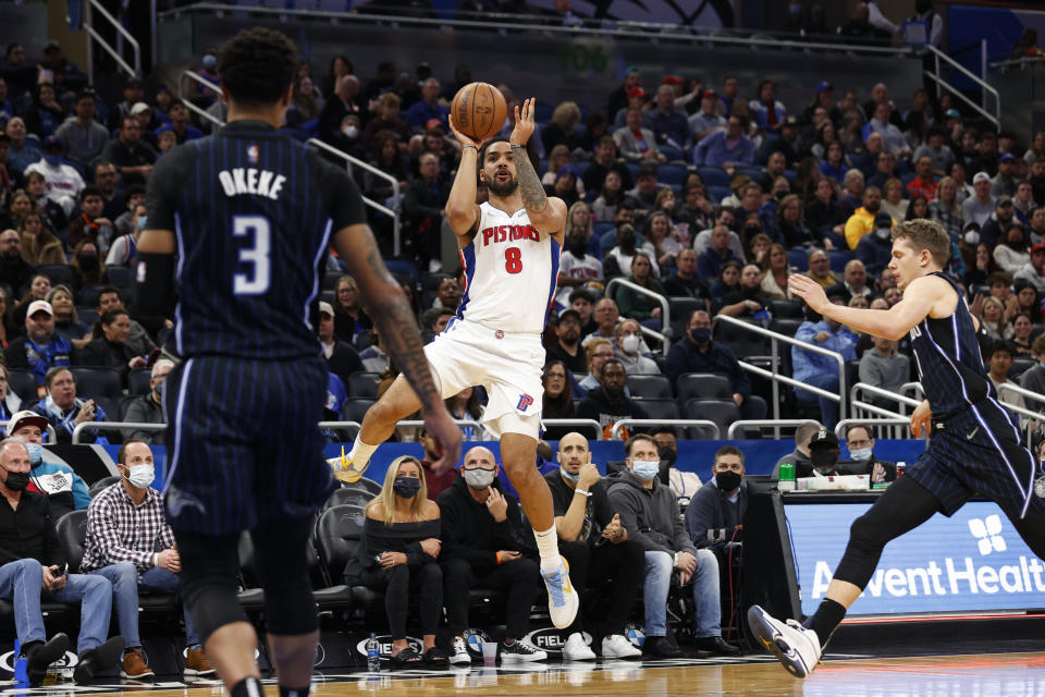 Detroit Pistons forward Trey Lyles (8) puts up a shot against Orlando Magic forward Chuma Okeke (3) and Orlando Magic center Moritz Wagner during the first half of an NBA basketball game Friday, Jan. 28, 2022, in Orlando, Fla. (AP Photo/Scott Audette)