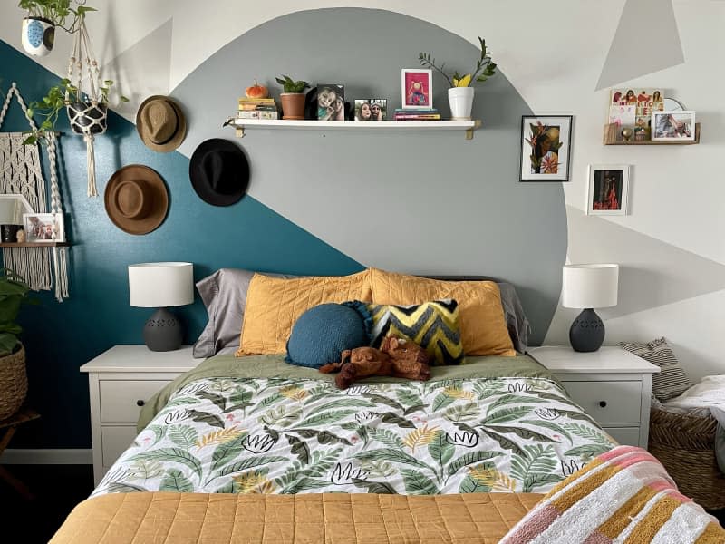 Bedroom with gray and teal shapes painted on wall