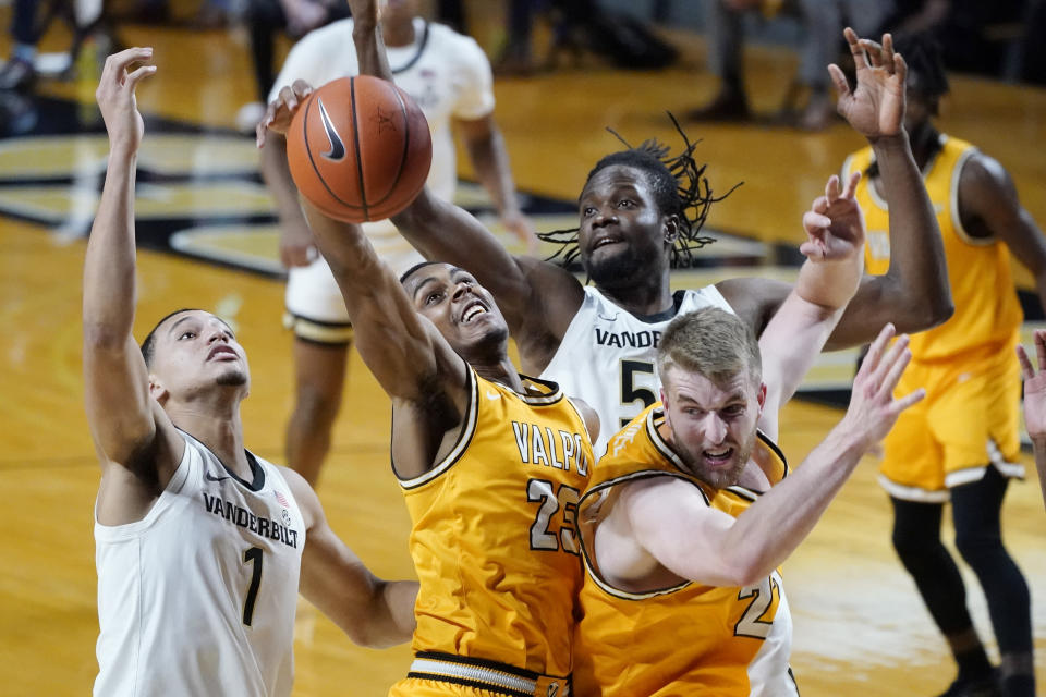 Valparaiso guard Nick Robinson (25) grabs a rebound between Vanderbilt's Dylan Disu (1) and Ejike Obinna (50) in the first half of an NCAA college basketball game Friday, Nov. 27, 2020, in Nashville, Tenn. (AP Photo/Mark Humphrey)