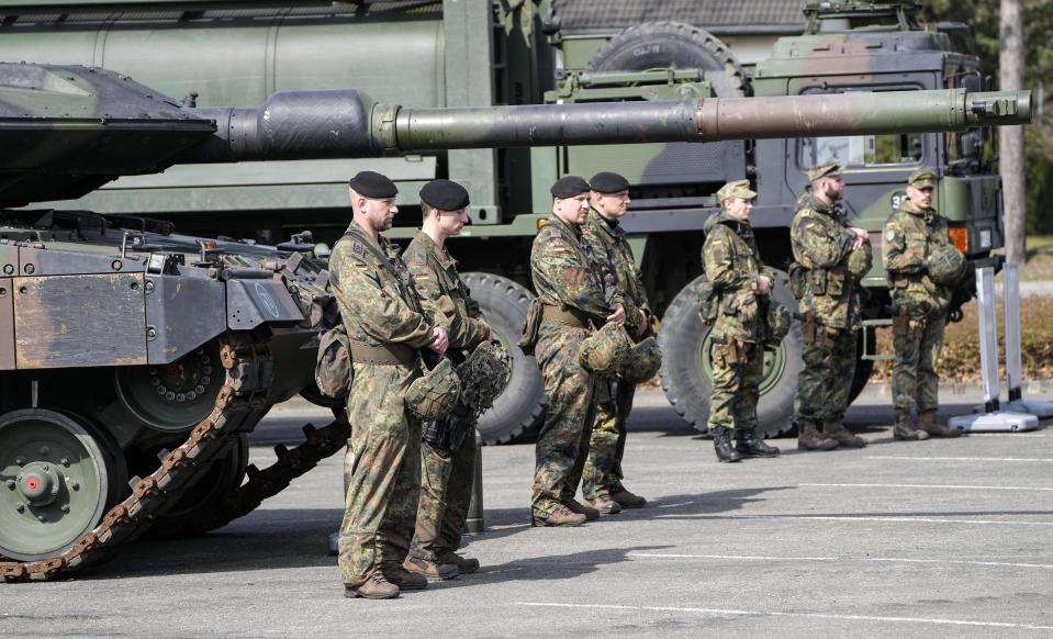 FILE -German soldiers stand at a Leopard tank during a visit of Governor Hendrick Wuest at the army base Field Marshal Rommel Barracks in Augustdorf, Germany, Wednesday, March 30, 2022. Poland will apply to the German government for permission to supply the German-made Leopard battle tanks to Ukraine. (AP Photo/Martin Meissner, File)