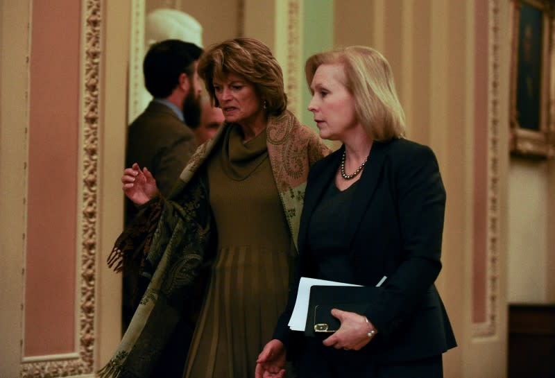 Sen. Lisa Murkowski, R-AK and Sen. Kirsten Gillibrand, D-NY chat while returning from a dinner break to the Senate impeachment trial of President Donald Trump