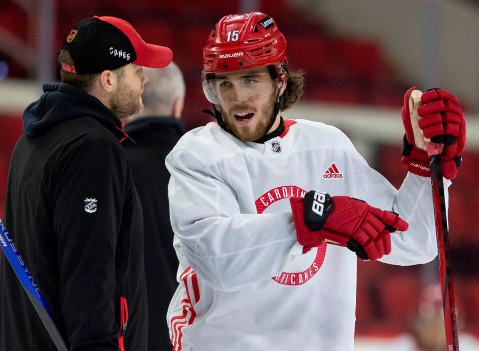 Carolina Hurricanes defenseman Dylan Coghlan (15) talks with assistant coach <a class="link " href="https://sports.yahoo.com/nhl/players/2859/" data-i13n="sec:content-canvas;subsec:anchor_text;elm:context_link" data-ylk="slk:Tim Gleason;sec:content-canvas;subsec:anchor_text;elm:context_link;itc:0">Tim Gleason</a> during practice on Thursday, May 2, 2024 at PNC Arena in Raleigh, N.C. Coghlan wears a high-tech Kevlar undershirt with a collar to protect his neck from a possible skate cut. Robert Willett/rwillett@newsobserver.com