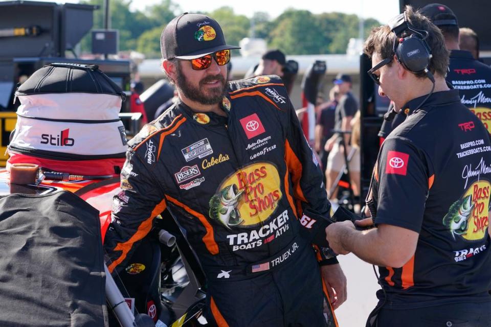Martin Truex Jr., left, talks with a crew member prior to practice and qualifying at Richmond Raceway for Sunday’s NASCAR Cup Series auto race Saturday, Aug. 13, 2022, in Richmond, Va. (AP Photo/Steve Helber)