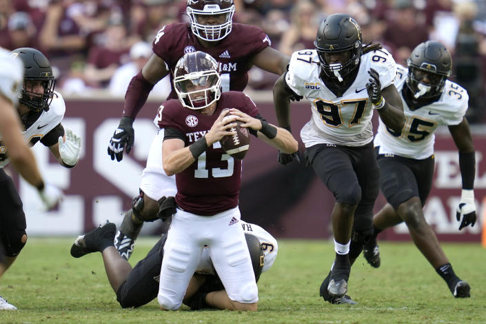 Texas A&amp;M quarterback Haynes King (13) is tackled by Appalachian State linebacker Nick Hampton (9) on Saturday, Sept. 10, 2022, in College Station, Texas. (AP Photo/Sam Craft)
