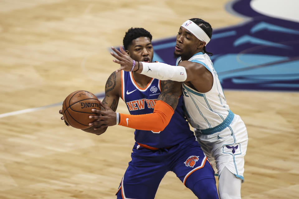 Charlotte Hornets guard Devonte' Graham, right, disrupts New York Knicks guard Elfrid Payton in the first quarter of an NBA basketball game in Charlotte, N.C., Monday, Jan. 11, 2021. (AP Photo/Nell Redmond)