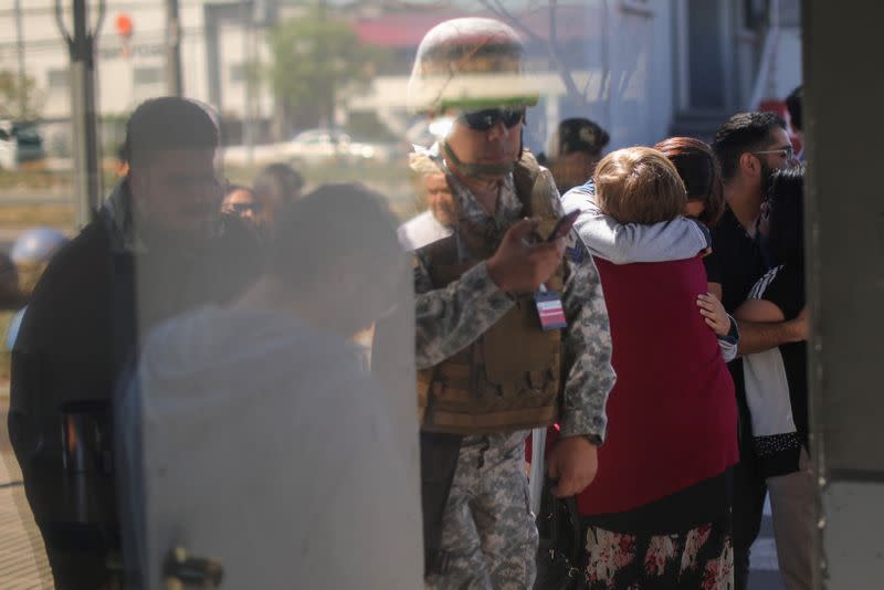 People react inside an air force base in Santiago