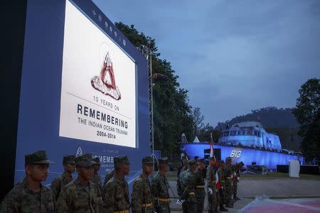 Thai soldiers stand guard as they practice ahead of the tenth anniversary of the 2004 tsunami at the police boat T813 tsunami memorial in Khao Lak, Phang Nga province December 25, 2014. REUTERS/Athit Perawongmetha