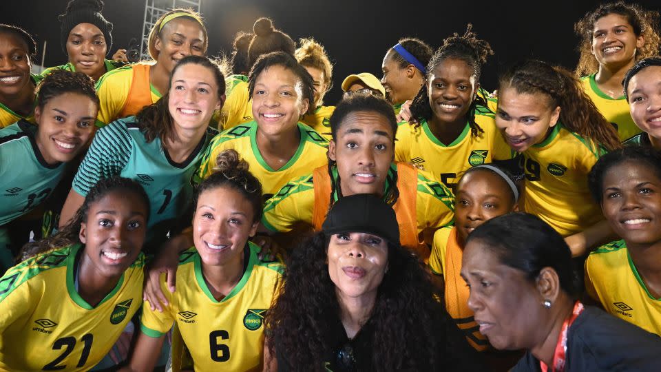 Cedella Marley (C bottom) poses with Jamaica's national team ahead of the Women's World Cup in 2019. - Angela Weiss/AFP/Getty Images