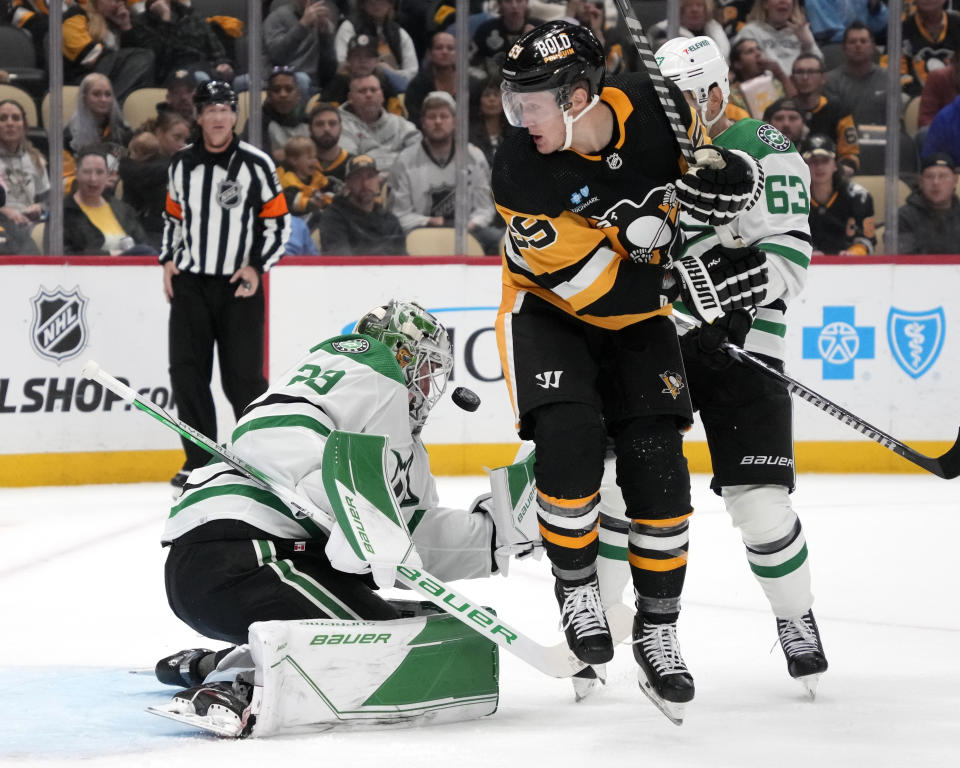 Pittsburgh Penguins' Jake Guentzel (59) can't get to a rebound off Dallas Stars goaltender Jake Oettinger (29) with Evgenii Dadonov (63) defending during the second period of an NHL hockey game in Pittsburgh, Tuesday, Oct. 24, 2023. (AP Photo/Gene J. Puskar)