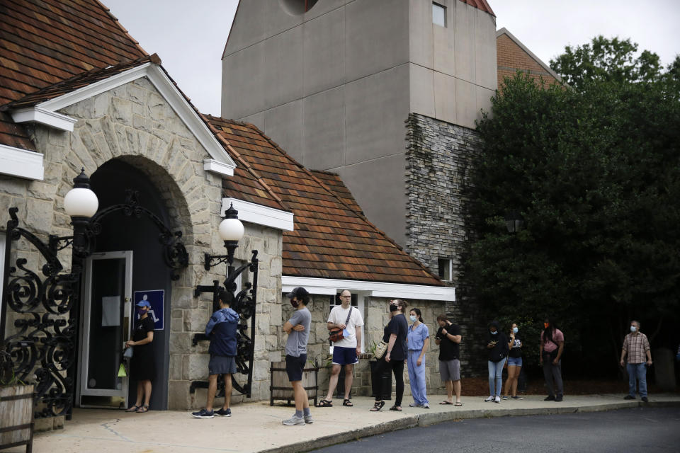 People wait in a line to vote in the Georgia's primary election at Park Tavern on Tuesday, June 9, 2020, in Atlanta. (AP Photo/Brynn Anderson)