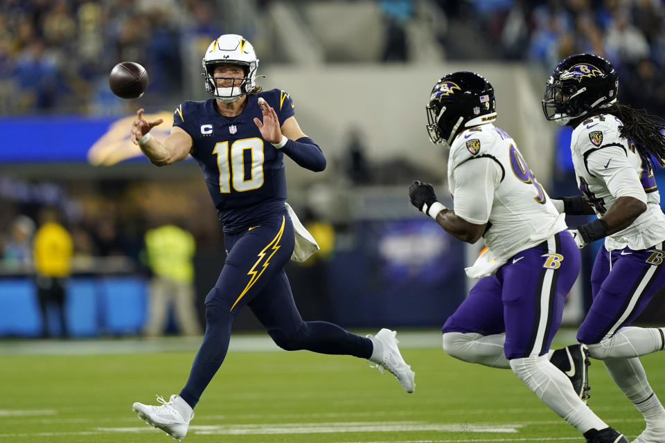 Los Angeles Chargers quarterback Justin Herbert (10) throws on the run during the first half of an NFL football game against the Baltimore Ravens, Sunday, Nov. 26, 2023, in Inglewood, Calif. (AP Photo/Ryan Sun)