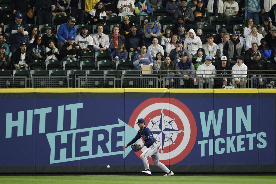 Tampa Bay Rays right fielder Brett Phillips goes after a double by Seattle Mariners' Adam Frazier during the first inning of a baseball game Friday, May 6, 2022, in Seattle. (AP Photo/Jason Redmond)