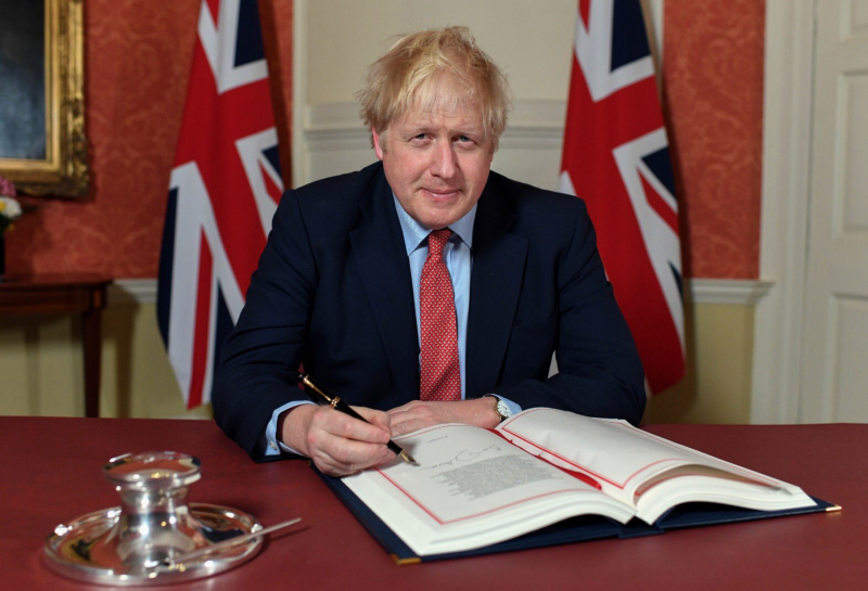 Boris Johnson marked the signing of the Withdrawal Agreement with a photo backed by Union Jacks (Picture: Twitter/Boris Johnson)