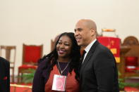 Before a Martin Luther King Jr. prayer service at Zion Baptist Church in Columbia, S.C., Monday, January 21, 2019, Sen. Cory Booker, D-N.J., stops for a photo with an attendee. Booker and Vermont Sen. Bernie Sanders visited the state as they mull 2020 challenges to President Donald Trump. (AP Photo/Meg Kinnard)