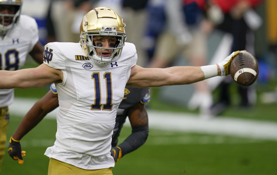 Notre Dame wide receiver Ben Skowronek (11) celebrates as he goes in the end zone past Pittsburgh defensive back A.J. Woods (25) for a touchdown after making a catch during the first half of an NCAA college football game, Saturday, Oct. 24, 2020, in Pittsburgh. (AP Photo/Keith Srakocic)