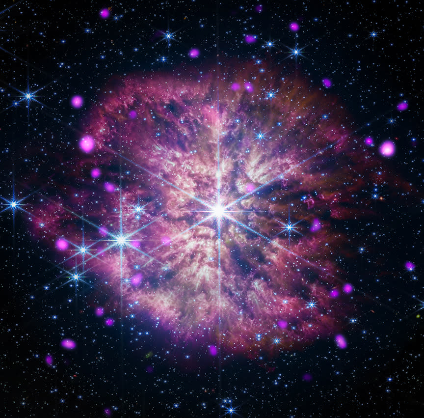 A bright pink explosion seems to be happening in space. Glowing area right in the middle of the explosion.