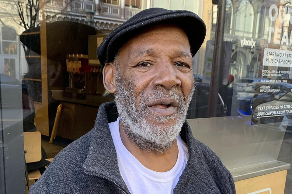 Sylvester Harris, a 54-year-old Washington native who panhandles near Capital One Arena, poses for a photo on Thursday, Dec. 7, 2023, in Washington. (AP Photo/Ashraf Khalil)