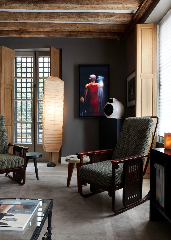 This detail shows a work by Bill Viola on the wall from 2007 called The Return and furniture by Josef Hoffmann, Charlotte Perriand, and Isamu Noguchi.