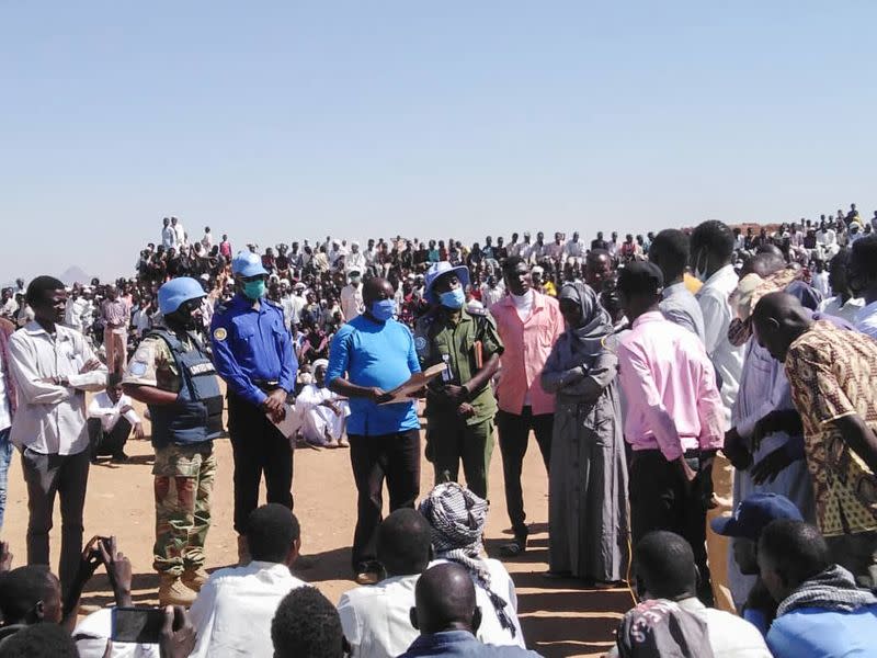 Peacekeepers from the United Nations Hybrid Operation receive a petition from protesters in Darfur