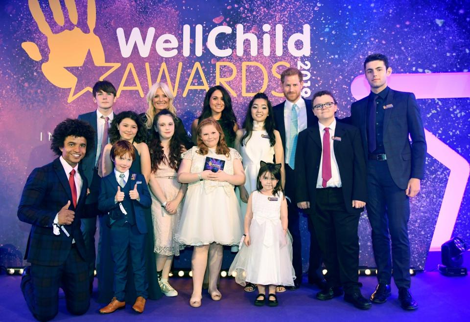 Harry and Meghan pose for a group photograph with award winners and presenters. (REUTERS)