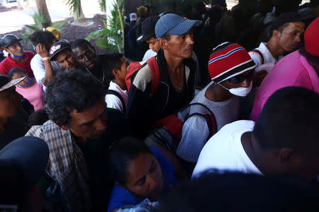 A group of Central American migrants, moving in a caravan through Mexico, arrive at the office of Mexico's National Institute of Migration to start the legal process and get temporary residence status for humanitarian reasons, in Hermosillo, Sonora state, Mexico April 24, 2018. REUTERS/Edgard Garrido