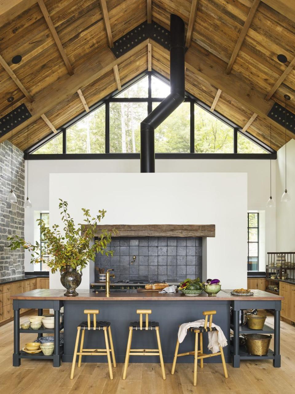 a kitchen with a large island in a deep gray color