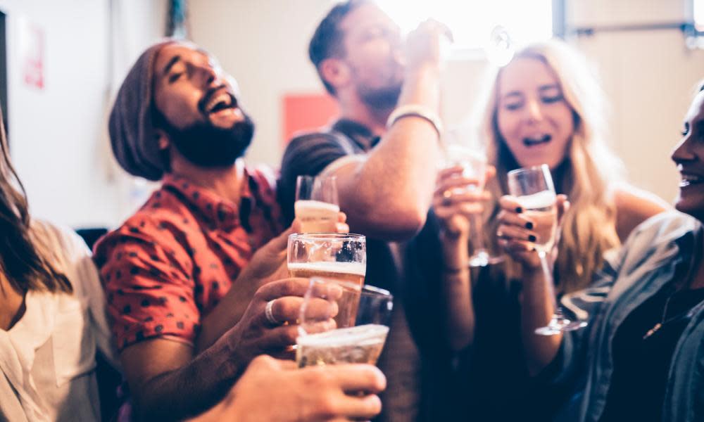 Men and women drinking alcohol in a bar