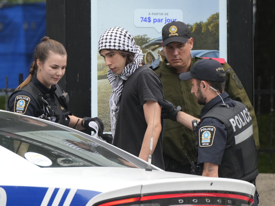 Police detain a protester as security clears the pro-Palestinian encampment at McGill University in Montreal, Wednesday, July 10, 2024. (Ryan Remiorz/The Canadian Press via AP)