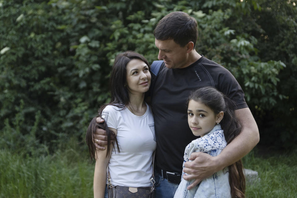 Milana Minenko, a 9-year-old child from Ukraine, right, enjoys a tender moment with her parents Oksana and Oleksandr Minenko, in a park in Warsaw, Poland, Wednesday June 7, 2023. Russian forces have destroyed 262 educational institutions and damaged another 3,019 in their invasion of Ukraine, according to government figures. For those who've fled to other countries, schooling is suffering in unprecedented ways, according to families, educators, experts and advocates. The effects of war and relocation combined with the challenges of studying in a new country are compounding educational setbacks for young refugees. (AP Photo/Michal Dyjuk)