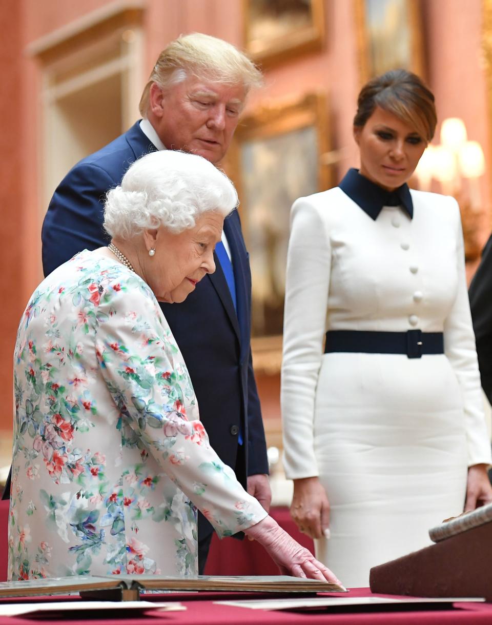 Britain's Queen Elizabeth II (L) views a display of US items of the Royal collection with US President Donald Trump and US First Lady Melania Trump at Buckingham palace at Buckingham Palace in central London on June 3, 2019, on the first day of their three-day State Visit to the UK. - Britain rolled out the red carpet for US President Donald Trump on June 3 as he arrived in Britain for a state visit already overshadowed by his outspoken remarks on Brexit. (Photo by MANDEL NGAN / AFP)        (Photo credit should read MANDEL NGAN/AFP/Getty Images)