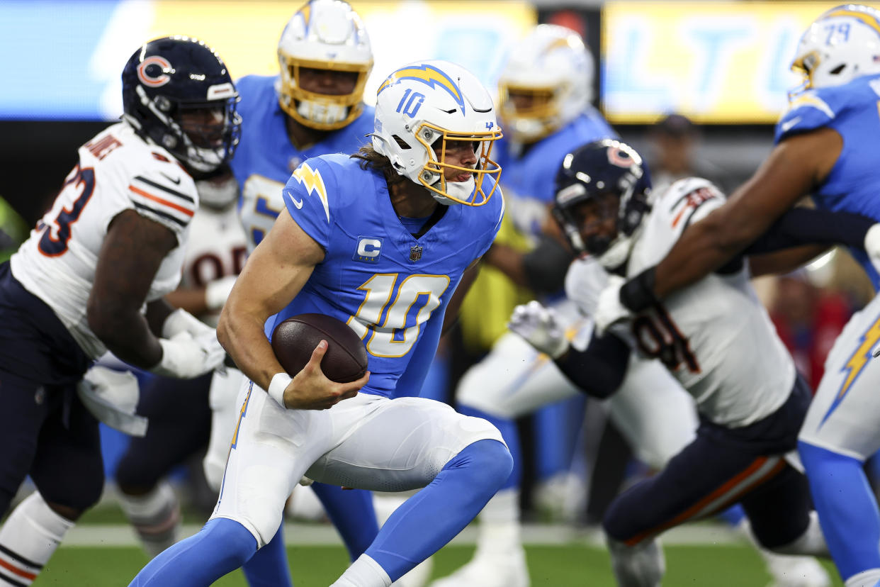 INGLEWOOD, CA - OCTOBER 29: Justin Herbert #10 of the Los Angeles Chargers carries the ball during the first quarter of an NFL football game against the Chicago Bears at SoFi Stadium on October 29, 2023 in Inglewood, California. (Photo by Kevin Sabitus/Getty Images)
