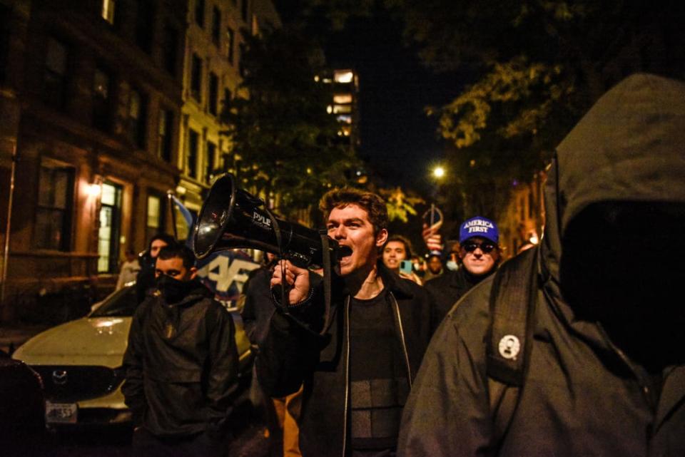 <div class="inline-image__caption"><p>Nicholas Fuentes marches through the streets while speaking to people associated with the far-right group America First at an anti-vaccine protest in front of Gracie Mansion on November 13, 2021 in New York City.</p></div> <div class="inline-image__credit">Stephanie Keith/Getty Images</div>