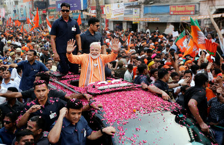 India's Prime Minister Narendra Modi waves towards his supporters during a roadshow in Varanasi, India, April 25, 2019. REUTERS/Adnan Abidi