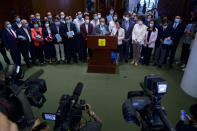 Pro-China lawmakers talk to reporters after attend the first and second reading of "Improving Electoral System (Consolidated Amendments) Bill 2021" at the Legislative Council in Hong Kong, Wednesday, April 14, 2021. Hong Kong’s electoral reform bill was introduced in the city’s legislature on Wednesday, setting in motion changes that will give Beijing greater control over the process while reducing the number of directly elected representatives. (AP Photo/Vincent Yu)