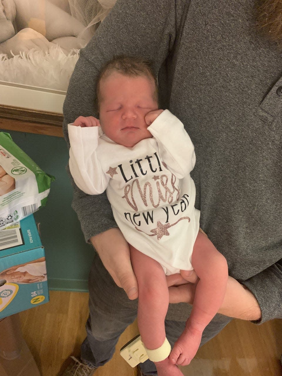 As is tradition, the first baby born in the new year receives a gift basket filled with goodies. As an additional gift, Mindy Green, RN at Family Birth Center, made the baby a “Little Miss New Year” onesie.