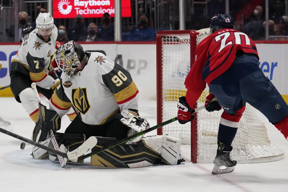 Vegas Golden Knights goaltender Robin Lehner (90) makes a save against Washington Capitals center Lars Eller (20) during the second period of an NHL hockey game, Monday, Jan. 24, 2022, in Washington. At left is Vegas Golden Knights defenseman Alex Pietrangelo. (AP Photo/Evan Vucci)