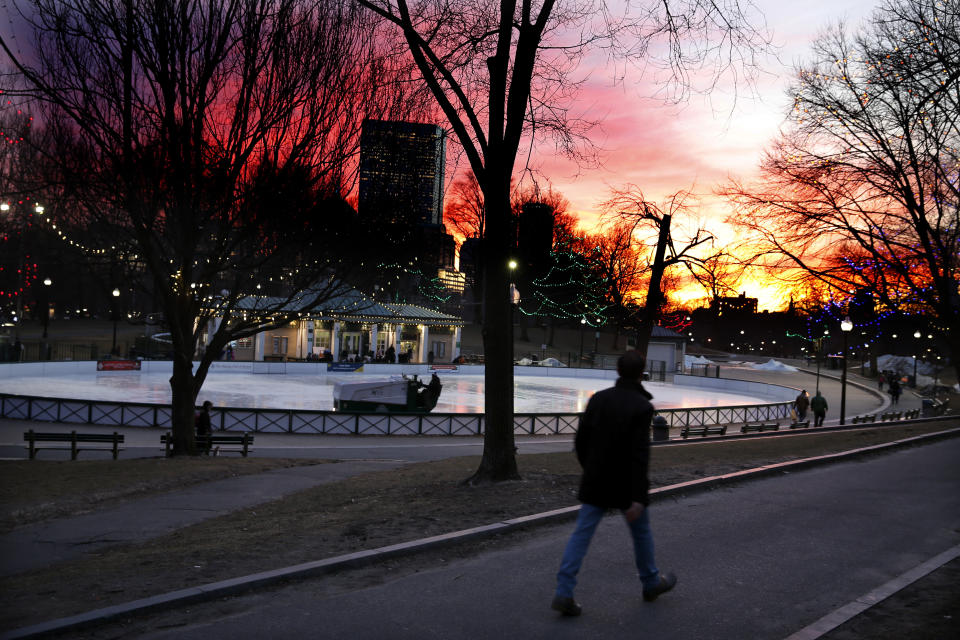 BOSTON, MA - JANUARY 28: Pedestrians pass by the Boston Common Frog Pond as an ice resurfacer drives across the skating surface at sunset on Jan. 28, 2019. (Photo by Matthew J. Lee/The Boston Globe via Getty Images)