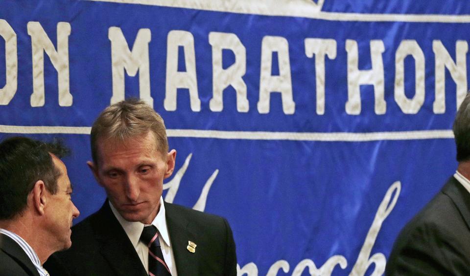 Boston Police Commissioner William Evans, second from left, listens to Boston Marathon Race Director Dave McGillivray during a news conference in preparation for the Boston Marathon, Wednesday, April 16, 2014, in Boston. (AP Photo/Charles Krupa)